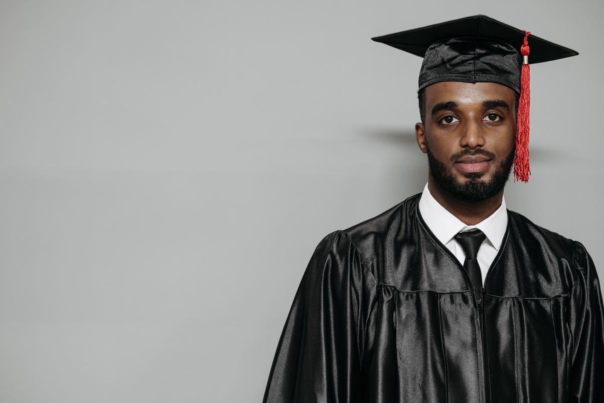 Photo of Man Wearing Black Graduation Gown 