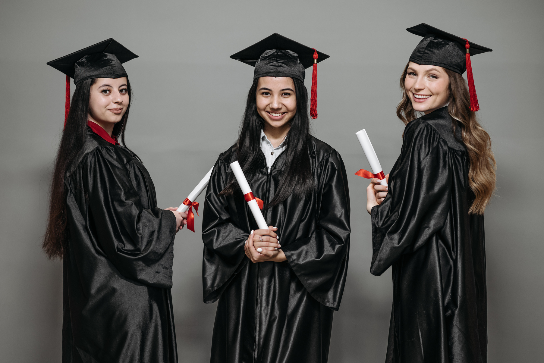 Photo of Women in Black Academic Dress Holding Diploma